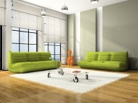Nowoczesne sofy w odcieniu zielonym kontrastujące z bielą i szarością pomieszczenia