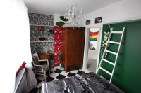 aranżacja zielono białej sypialni, z czerwonym wzorem na suficie